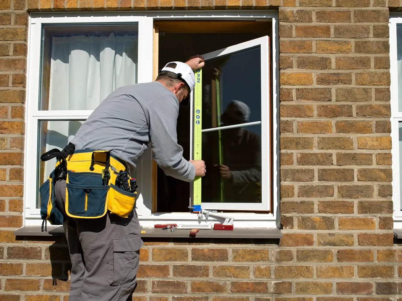 Installer fitting a new double glazed window in a home