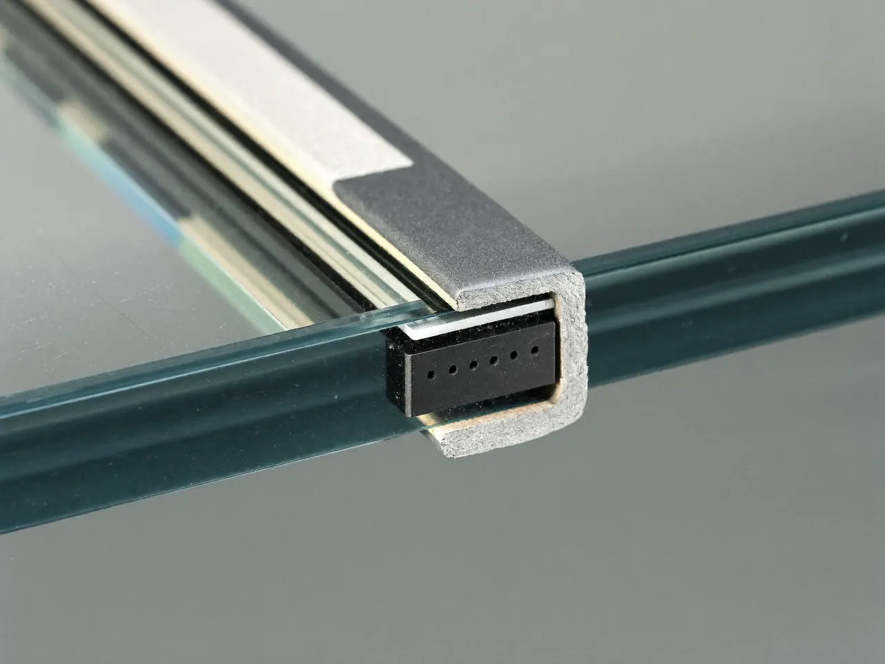 Close-up of a warm-edge spacer bar around the edge of a double glazed unit